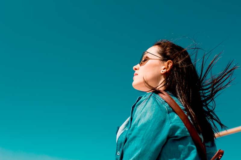 young girl looking out over sky landscape