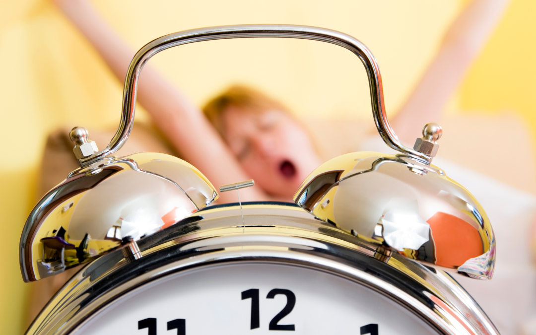 alarm clock with woman waking up in the background