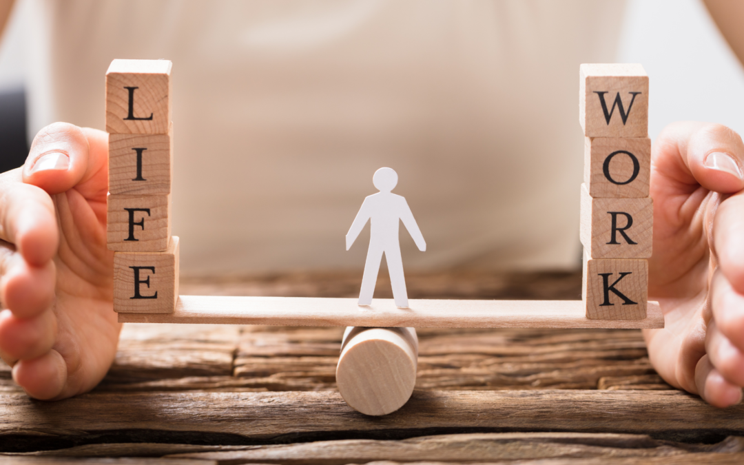 figure balancing blocks with the words life and work and hands around it